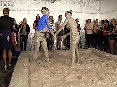 Everyone cheers as two hotties get buck wild during some mud wrestling