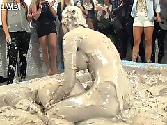 Wild brunette with a slim sexy body having a catfight in a mudbath