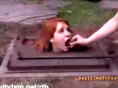 A cute redhead slave humiliated in bondage outdoor