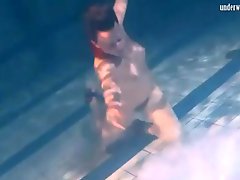 Cute girl drops her clothes in the pool to have fun