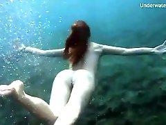 Skinny dipping redhead filmed underwater