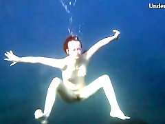 Redheaded girl is so sexy naked in the water