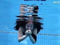 Babe in black bikini goes for a swim