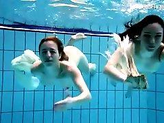 Nearly naked girls go swimming in the pool