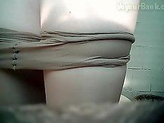 Pissing beauty is playing with her pussy in the toilet
