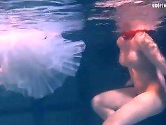 Cute ballerina swims in her shoes and tutu