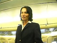 Short-haired brunette stewardess gets herself fucked by one of the passengers