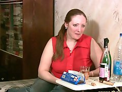 Chubby girl drinks and chats in jeans