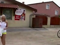 A blonde teenage girl is walking along the street where she meets a...