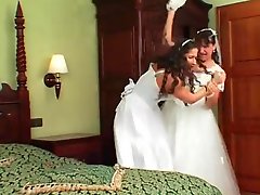 Two angry brides in dresses have a catfight
