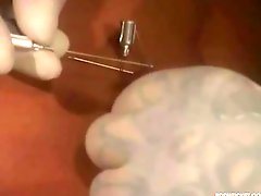 Needles slided throughout erect nipples