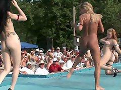 A few sexy tall chicks perform pole dances in public