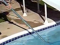 Cute black-haired babe rescuing a frog out of the pool