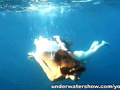 Nastya and Masha are swimming nude in the sea